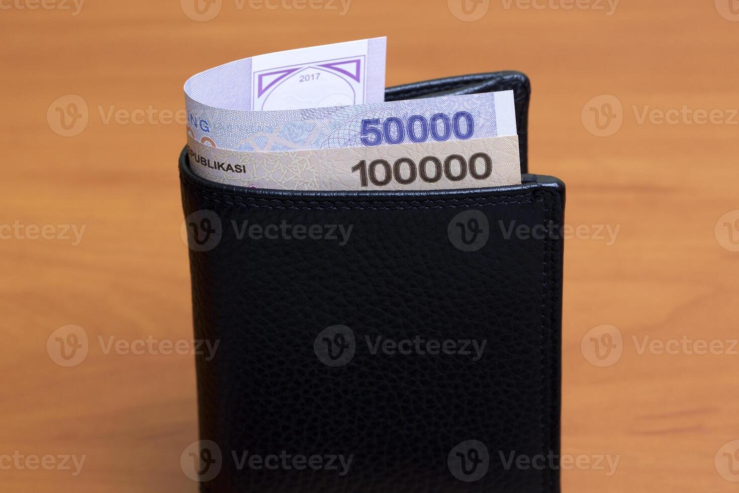 Uzbekistani sum in the black wallet photo