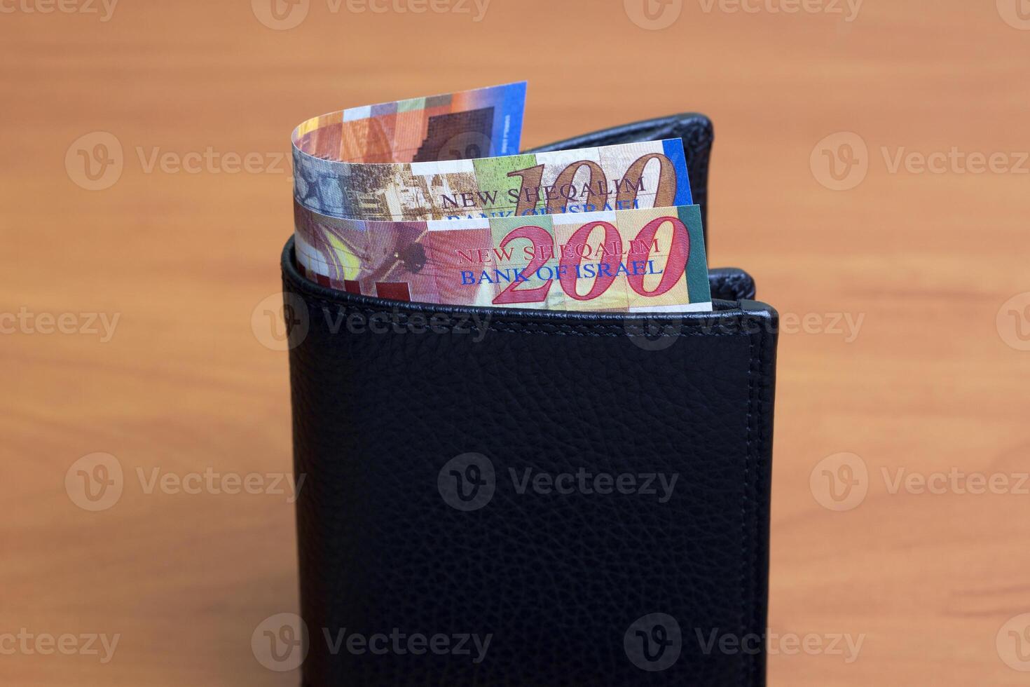 Israeli new shekel in the black wallet photo