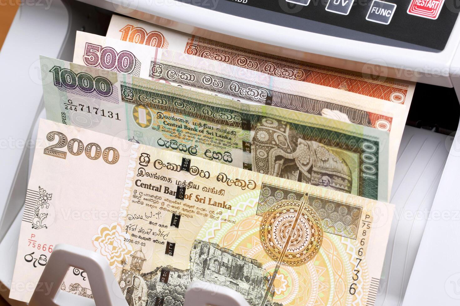 Old Sri Lankan rupee in the counting machine photo