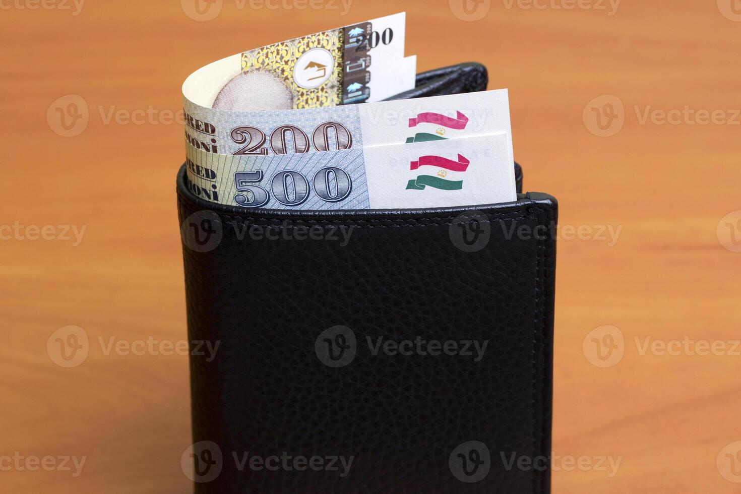 Tajikistani somoni in the black wallet photo