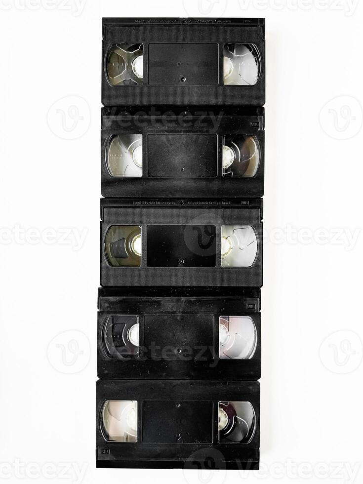 Vintage vhs cassettes stacked vertically on white background photo
