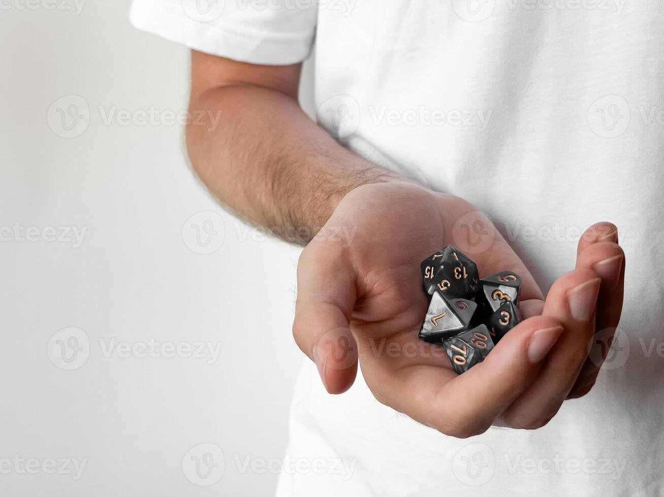 Person holding polyhedral dice set. gaming and role-playing symbolism photo
