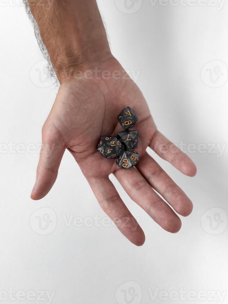 Hand holding dungeons and dragons dice on white background photo