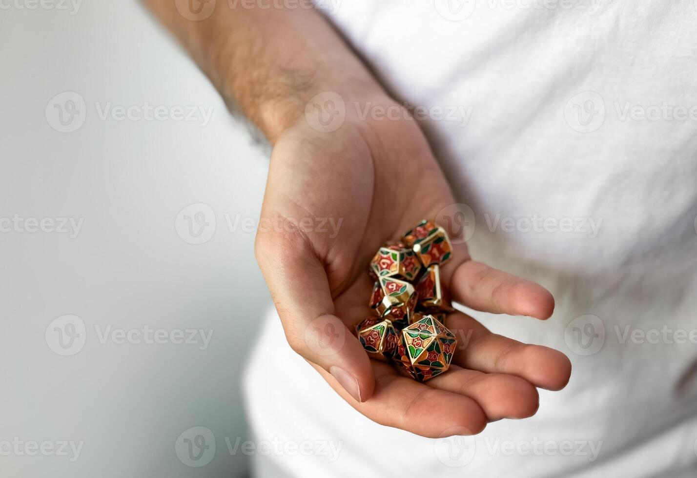 Hand holding colorful rpg dice for tabletop gaming and strategy photo