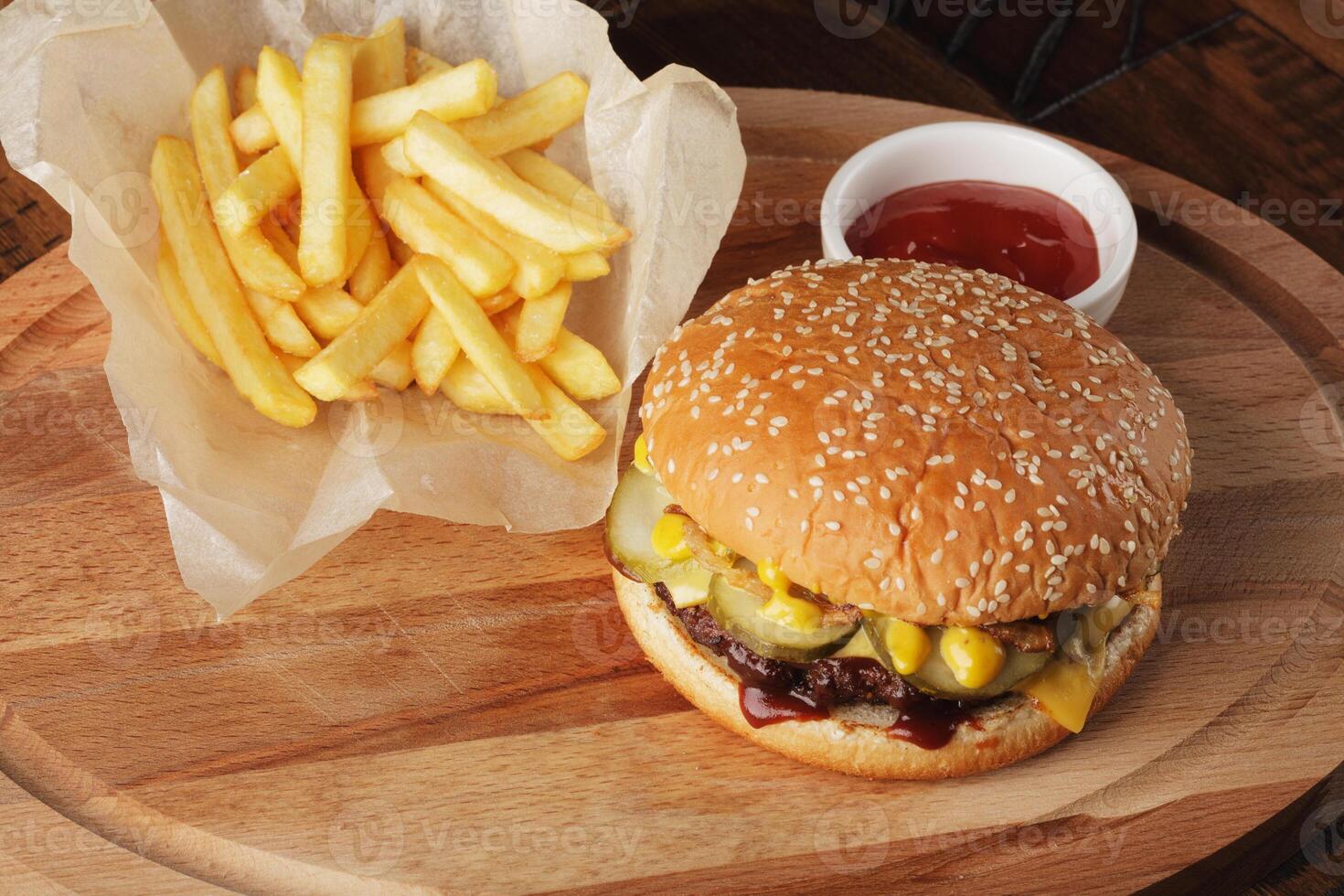 Hamburger with french fries and sauce. photo