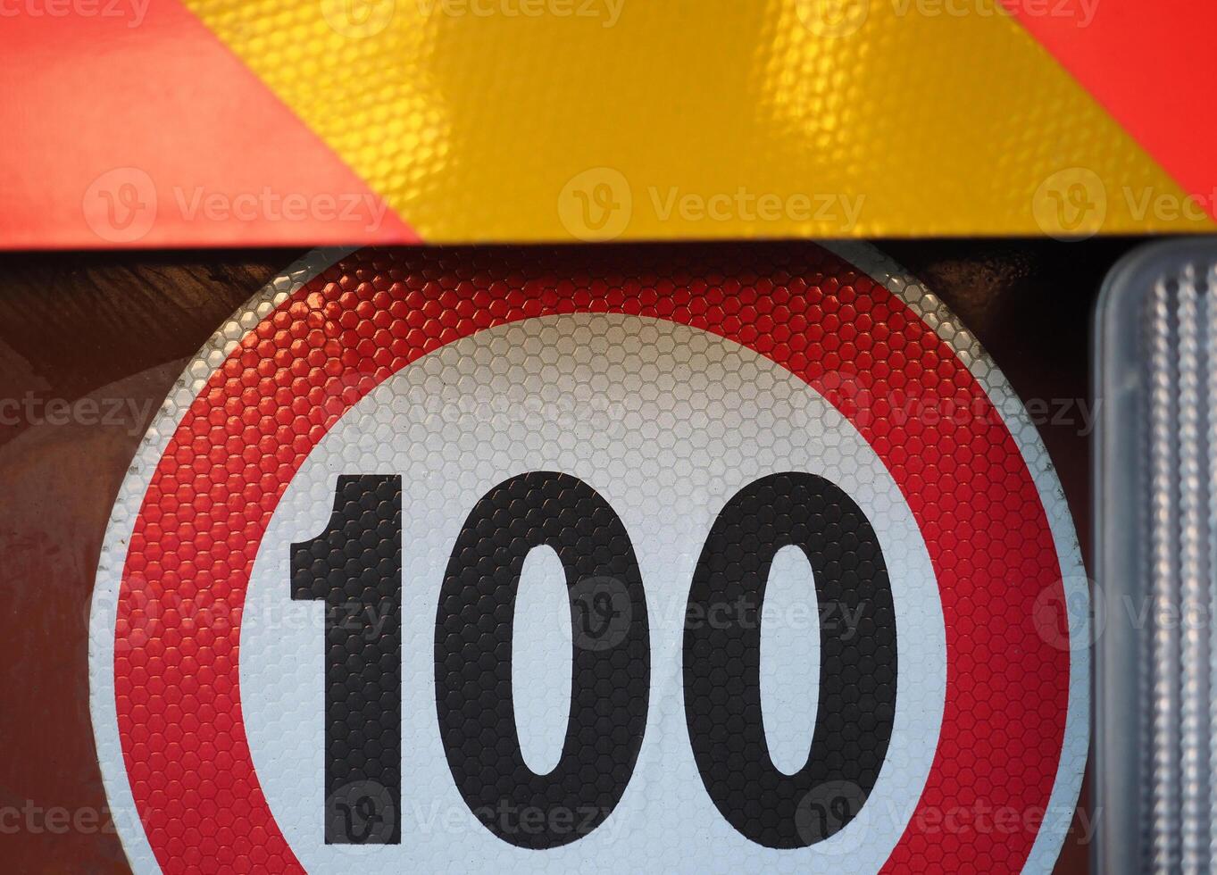 orange and yellow reflective panel and speed limit sign photo