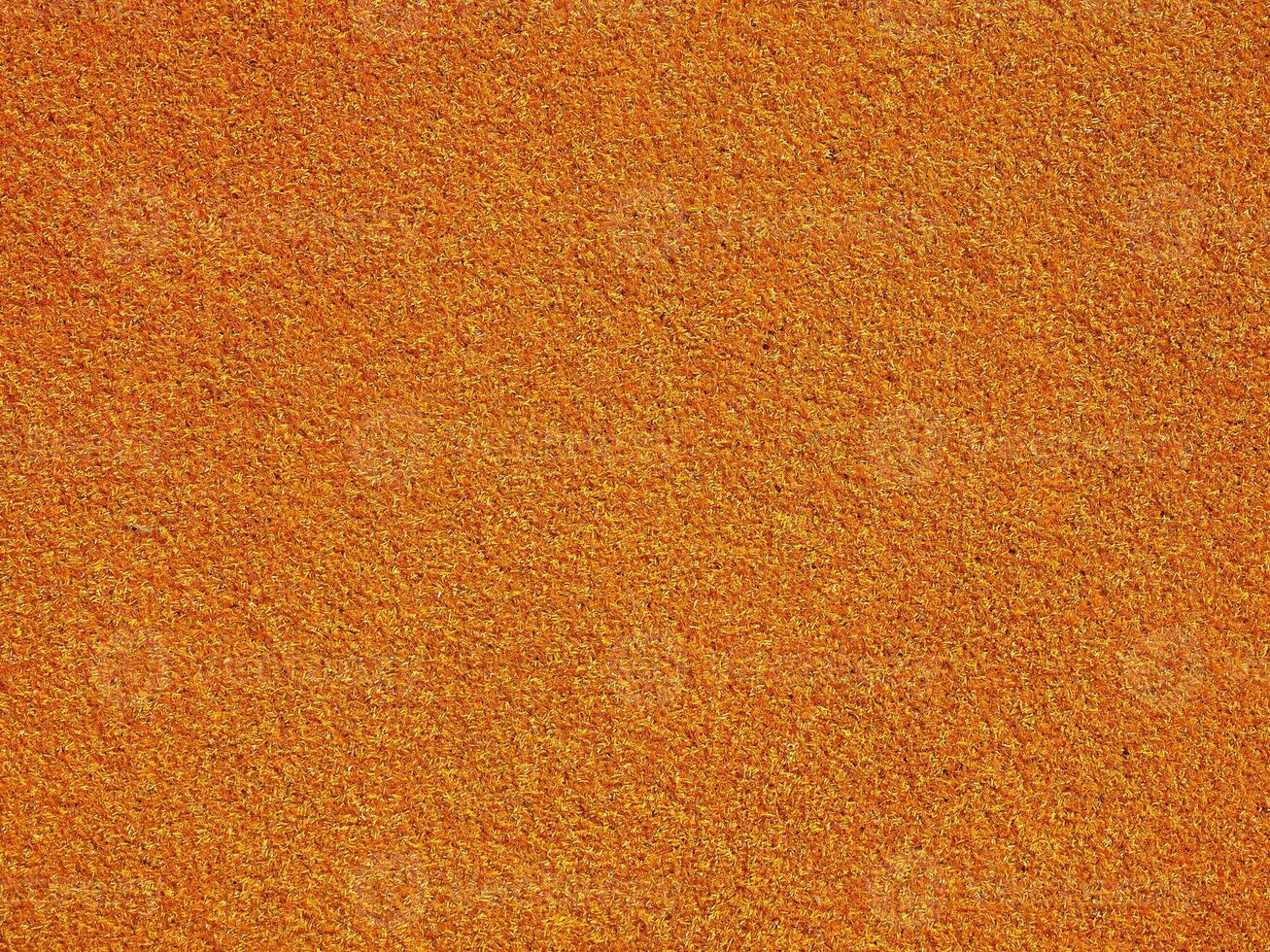 industrial style Orange artificial synthetic grass meadow backgr photo