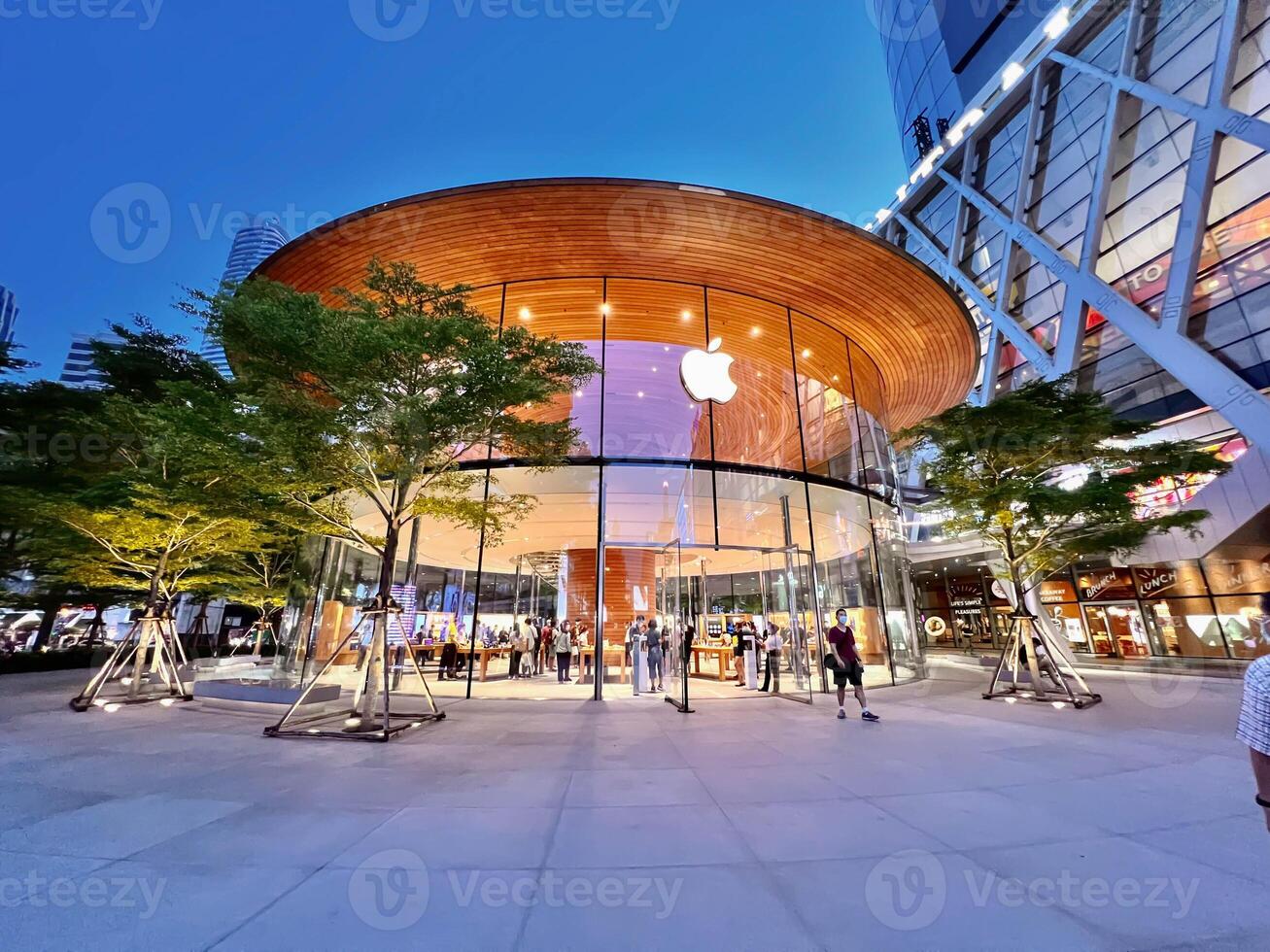 Bangkok city, TH 2022 - Front of the Apple store at the Central world shopping mall on office building and cityscape background., This store is the 2nd branch in Thailand. photo