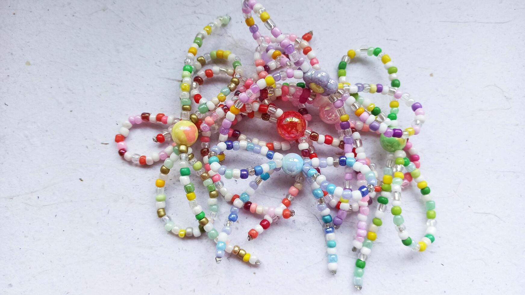 a bunch of beads are on a table and handmade ribbon from bead photo