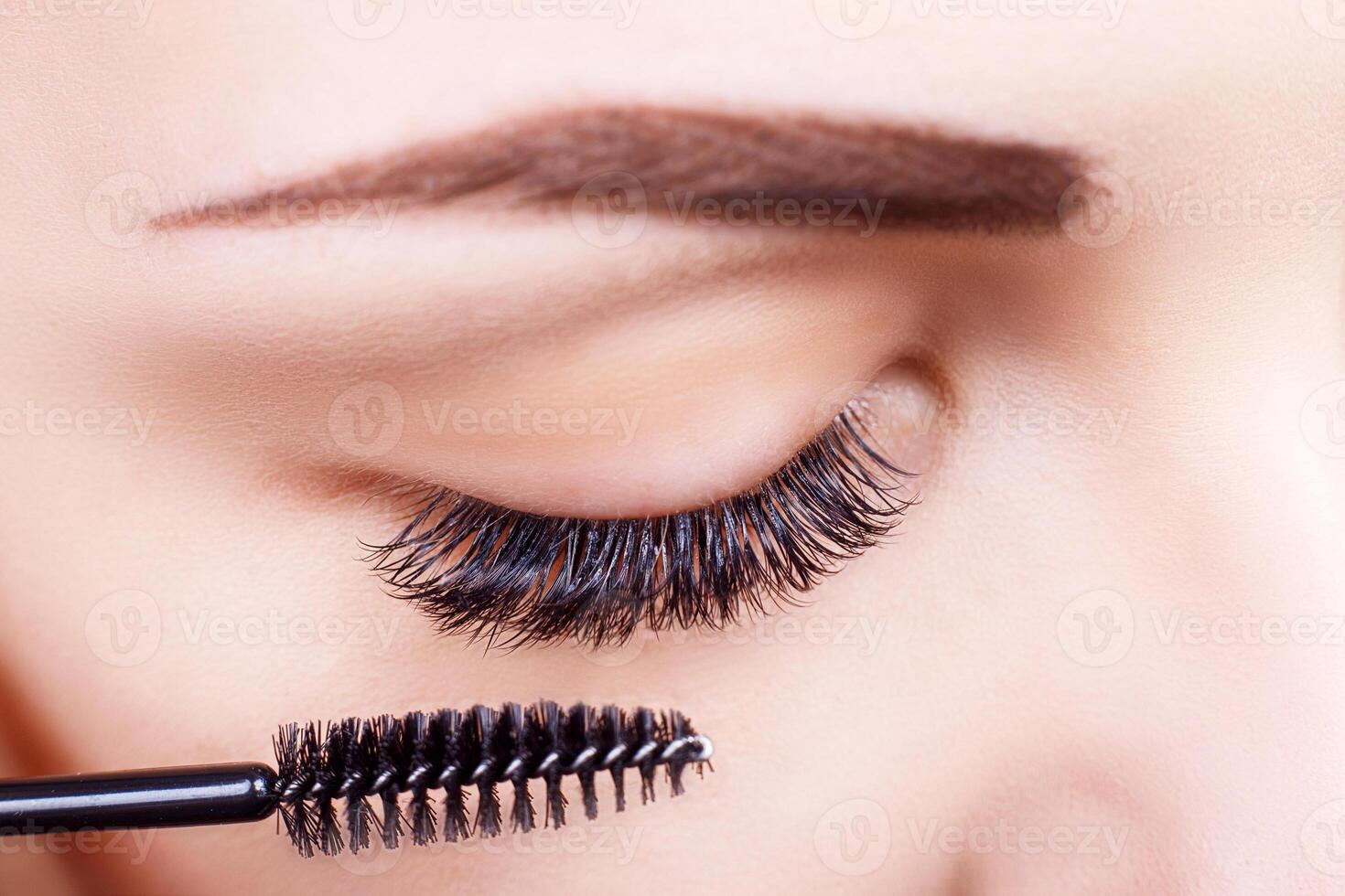 Eyelash Extension Procedure. Woman Eye with Long Eyelashes. Lashes, close up, macro, selective focus. photo