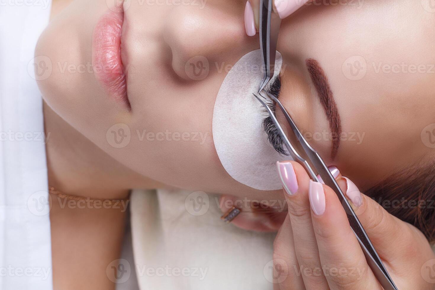 Eyelash Extension Procedure. Woman Eye with Long Eyelashes. Lashes, close up, macro, selective focus. photo