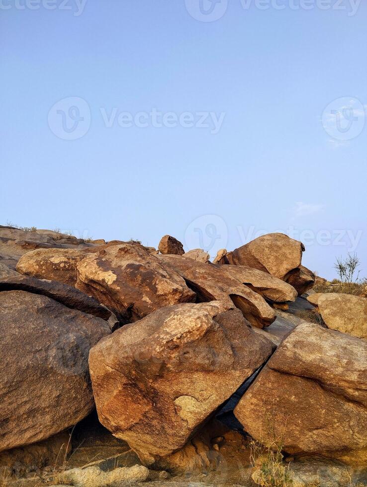 large rocks in the desert with a blue sky photo