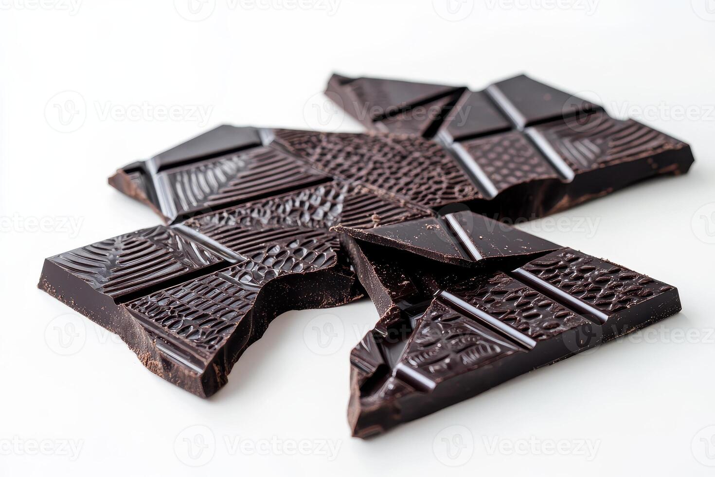 A broken chocolate bar with intricate patterns on its surface. photo
