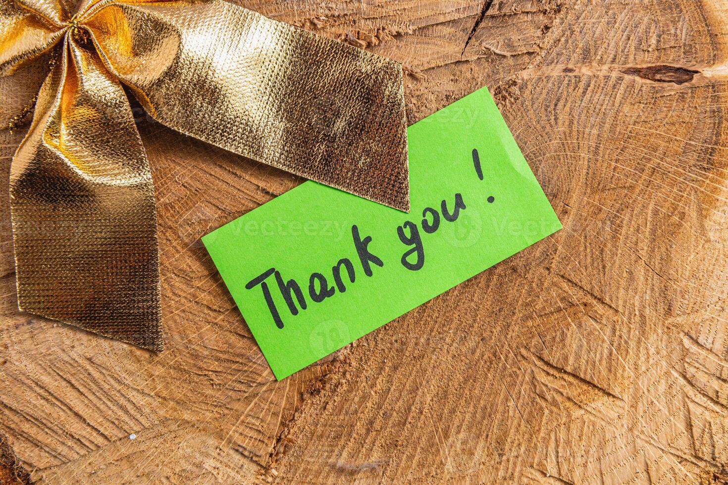 A word of thanks to a small green leaf on a piece of wood photo