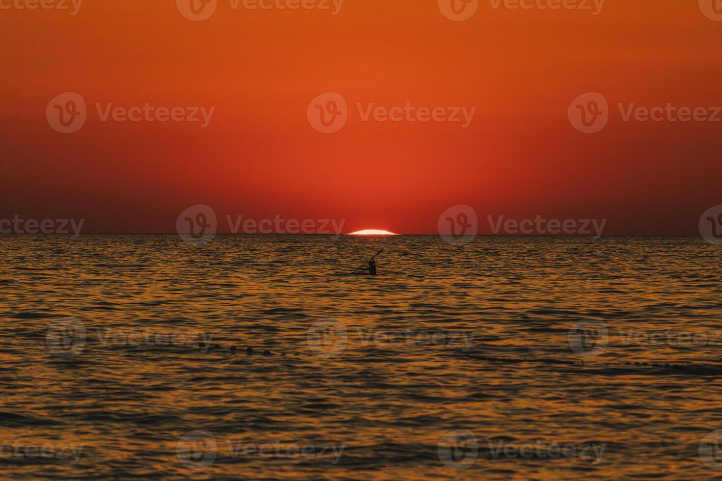 Amazing sunset with endless horizon and lonely figures in the distance Croatia photo