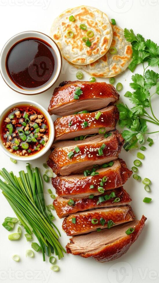 Roasted duck slices with glaze, green onions, and parsley on a white background photo