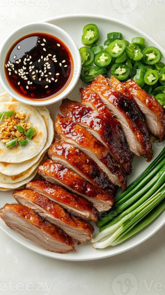 Sliced Peking Duck Served with Pancakes, Green Onions, and Chili Peppers photo
