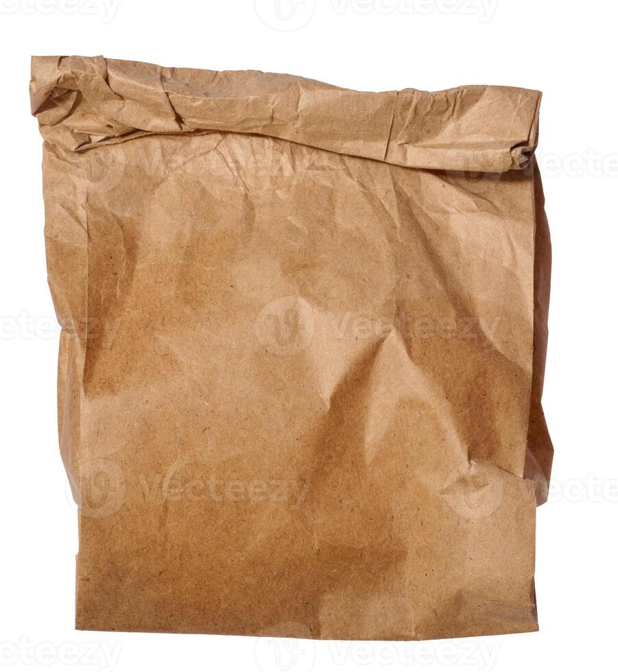 Brown kraft paper bag for packaging products in stores on an isolated background photo