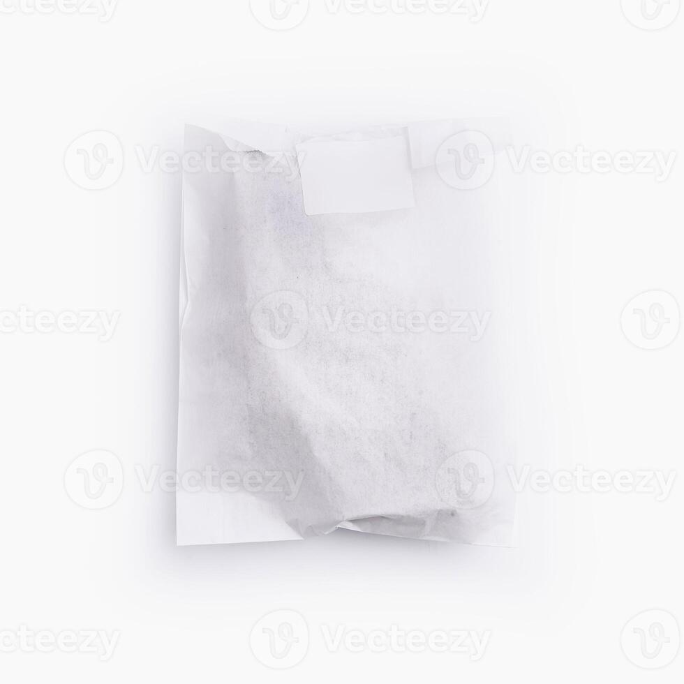 Crumpled white paper bag with blank label for branding mockup photo