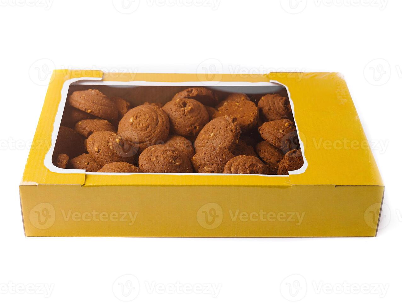Cardboard box full of round crispy cookies with nuts on white background photo