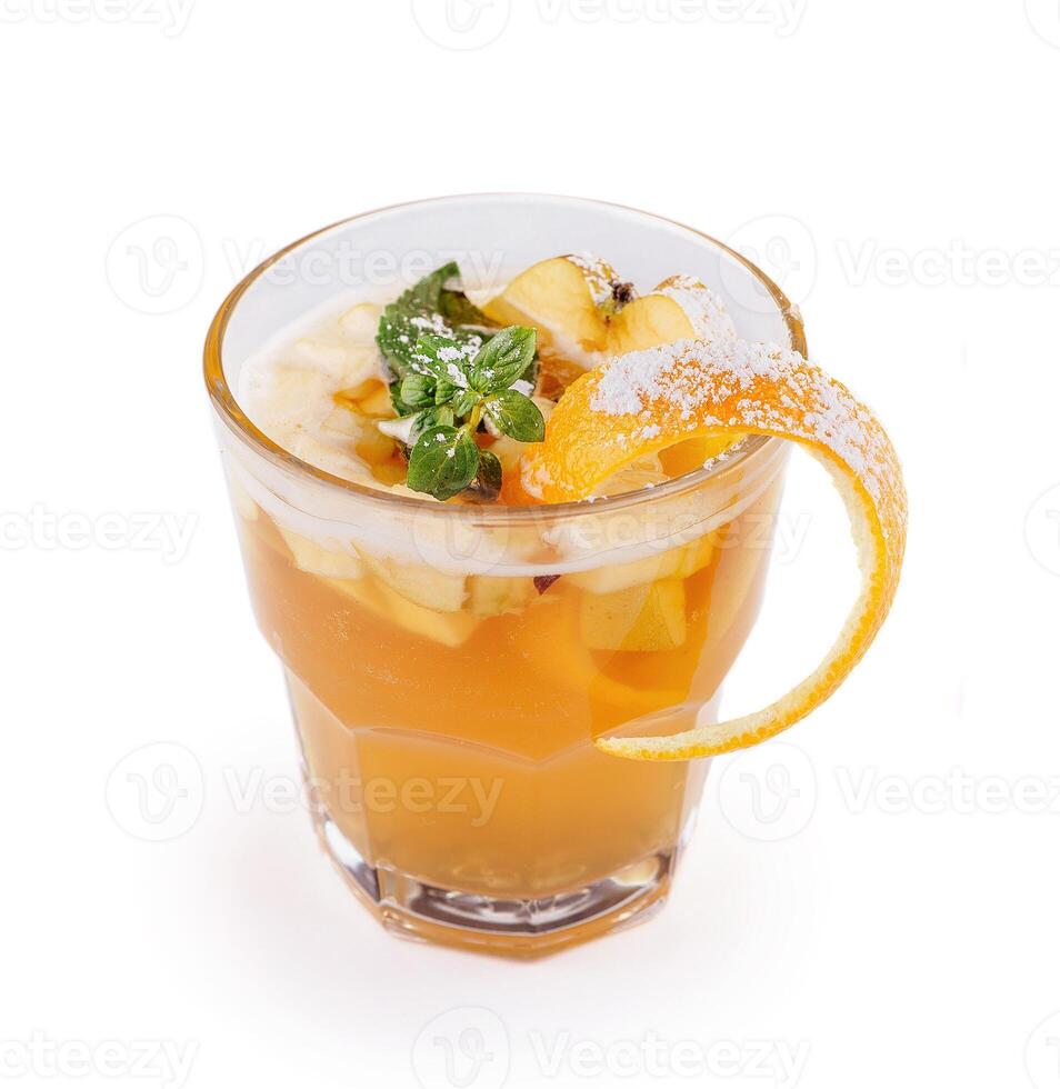 Refreshing iced tea with apple slices and orange peel in a glass photo