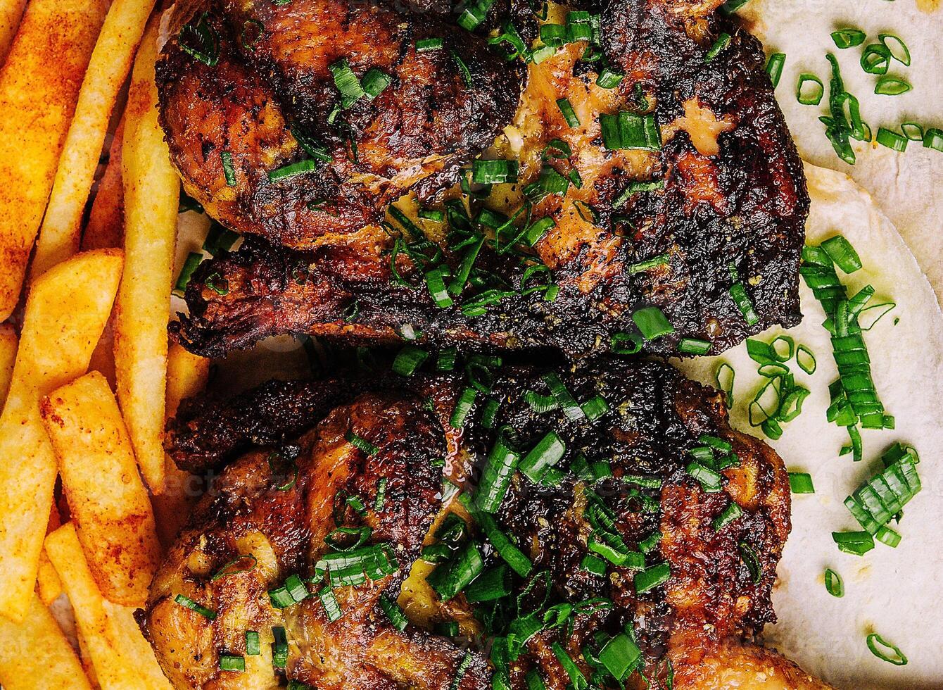 Juicy grilled pork chops with fries on plate photo