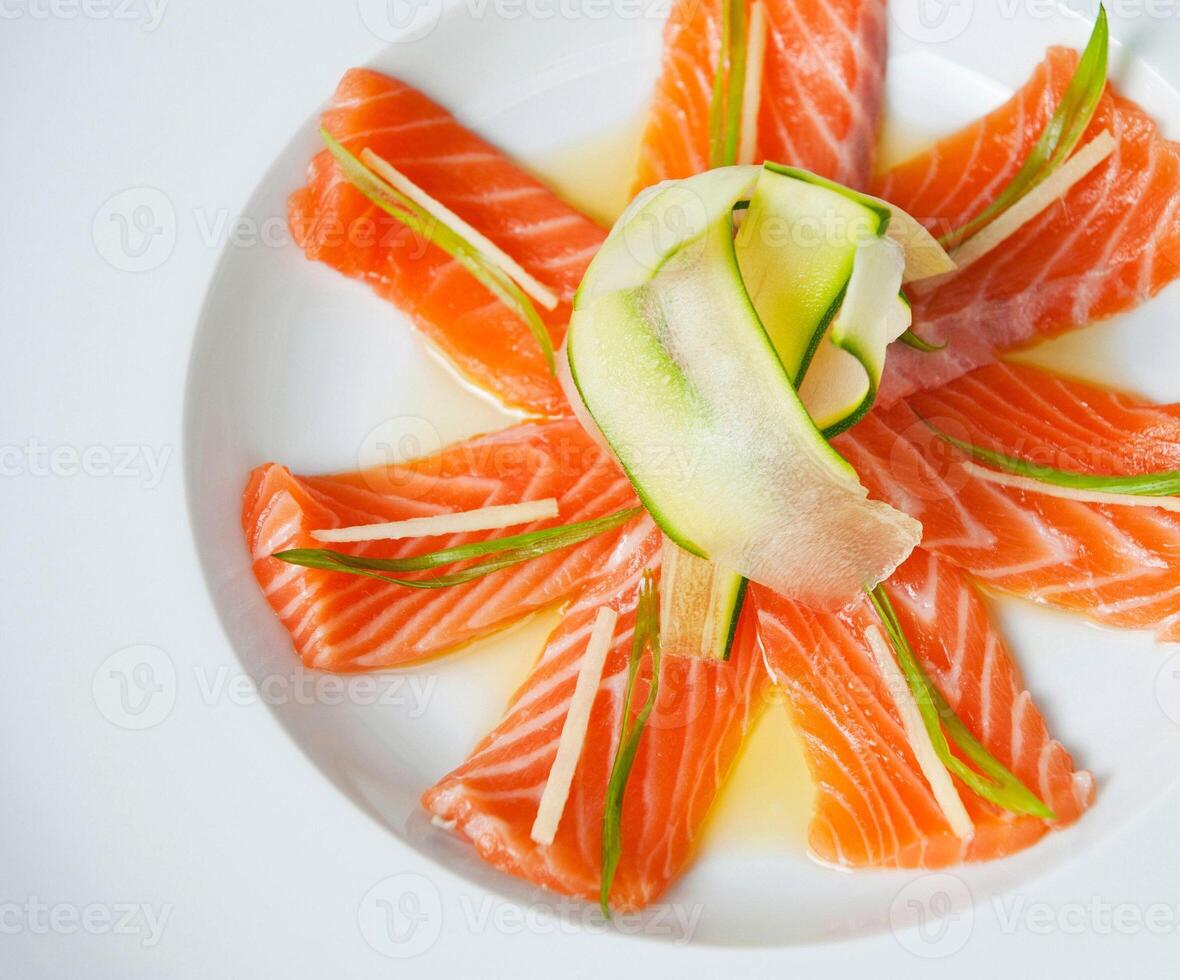 Fresh sashimi salmon platter with cucumber garnish photo