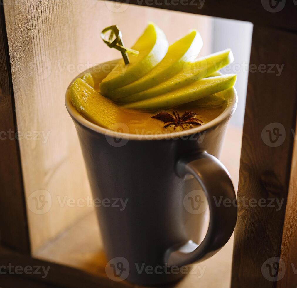 Warm spiced apple cider in a cozy mug photo