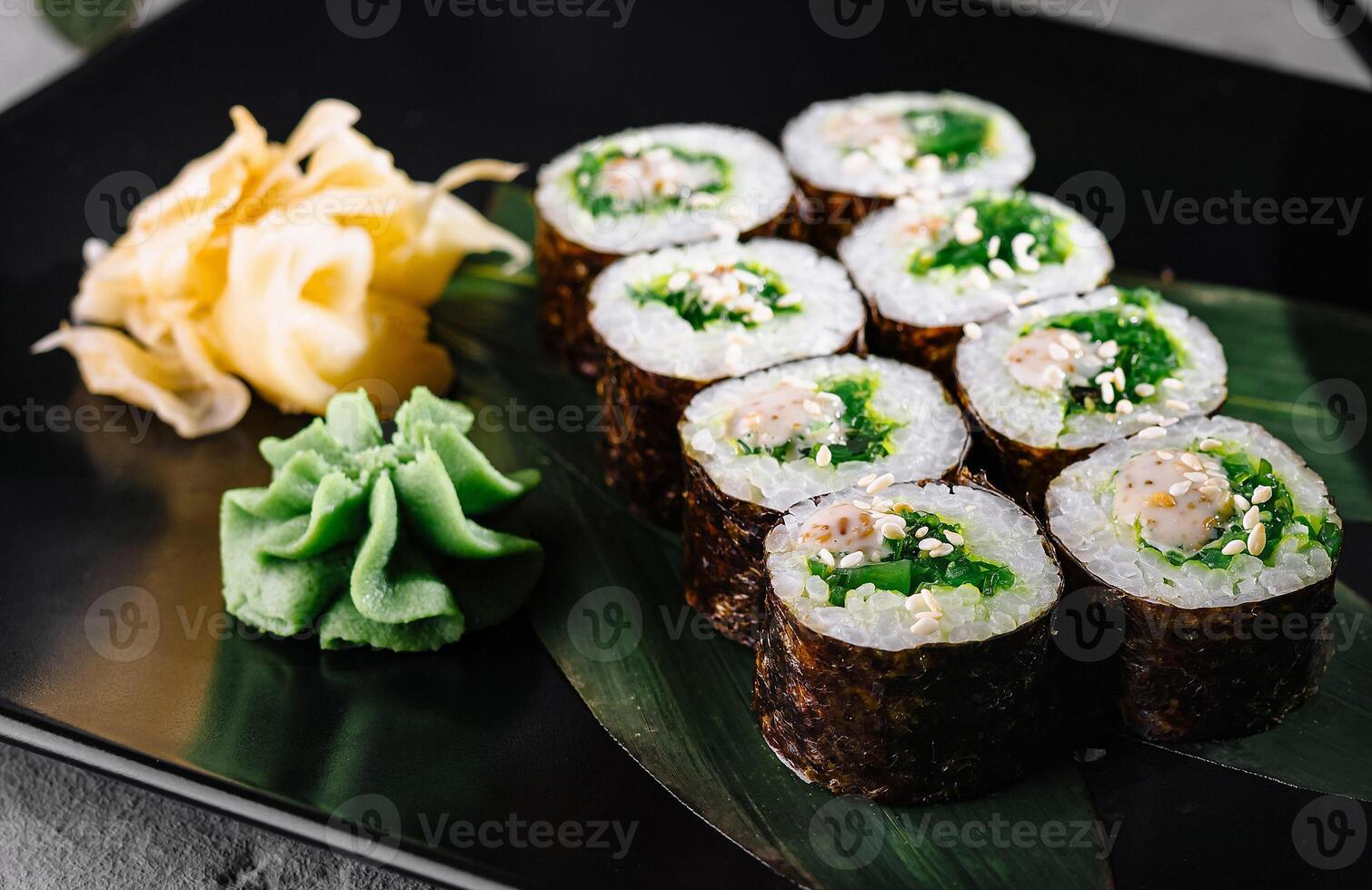 Elegant sushi roll display on black plate photo