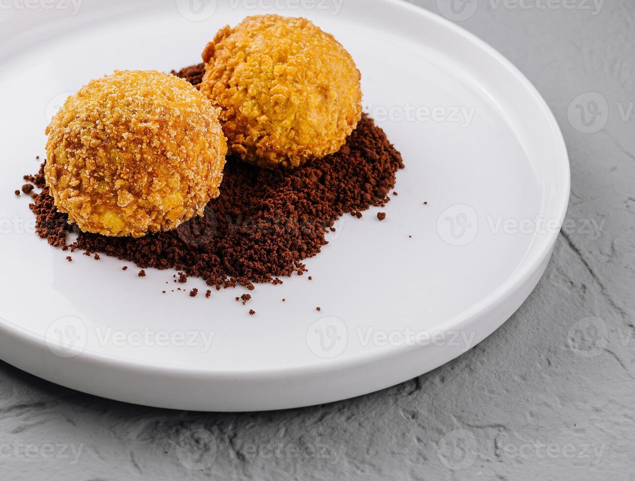 Gourmet truffles on white plate with cocoa dusting photo