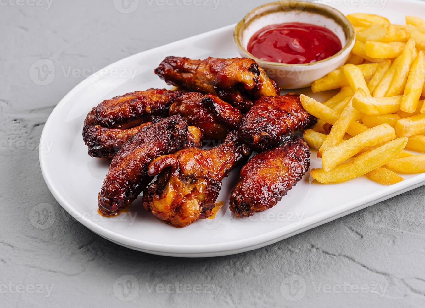 Crispy chicken wings and french fries with dipping sauce photo