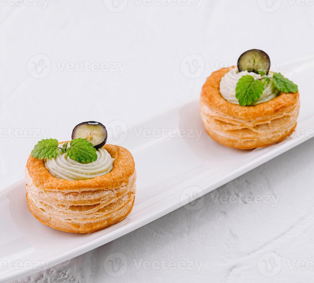 Elegant puff pastry appetizers on white plate photo