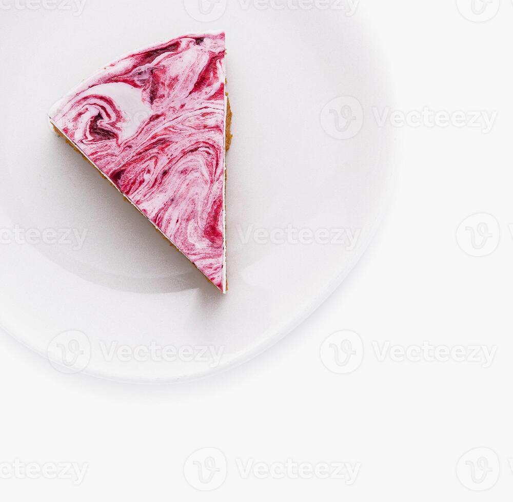 Artistic raspberry cheesecake slice on white plate photo