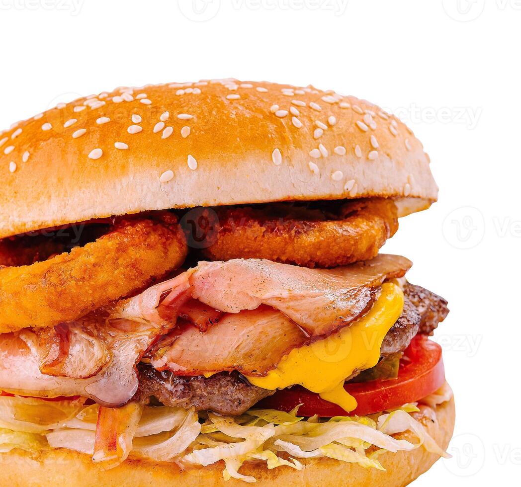 Delicious bacon and onion rings cheeseburger isolated on white photo