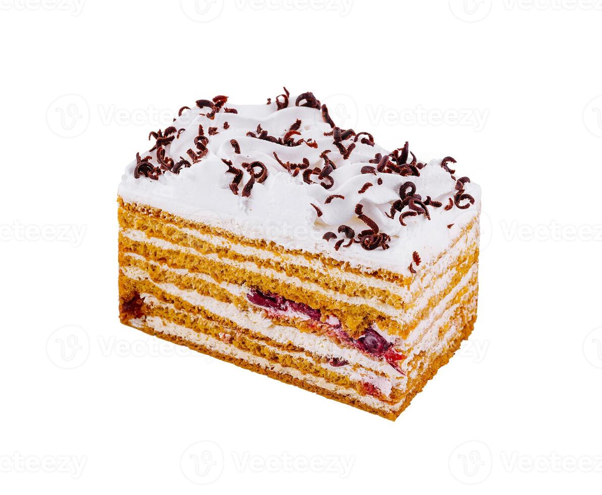 Delicious honey cake decorated with whipped cream and chocolate shavings photo