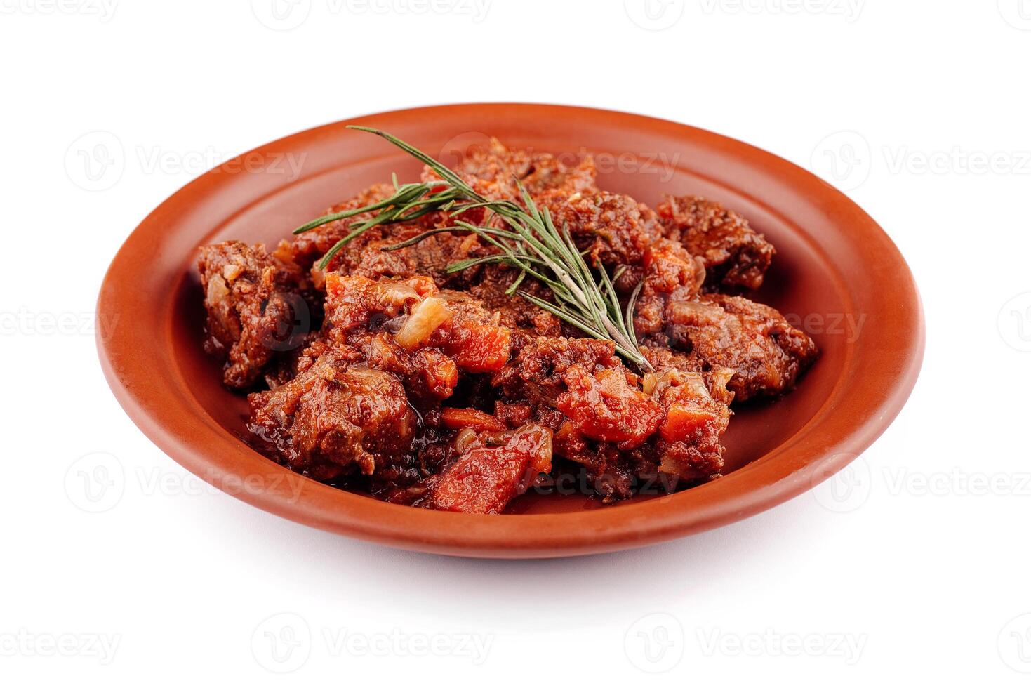 Delicious beef stew with vegetables simmering on plate photo
