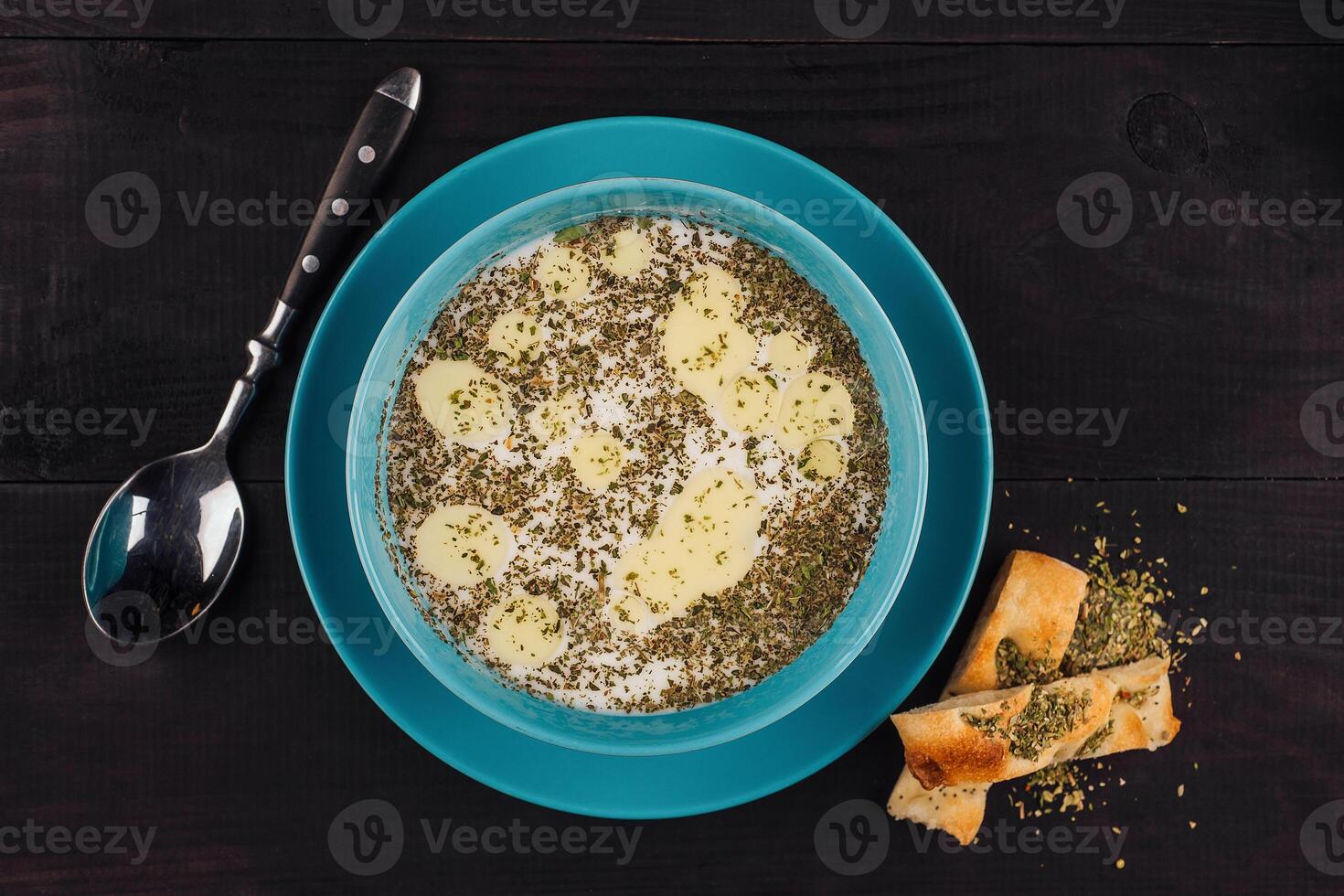Turkish yayla soup with dried mint and butter in a blue bowl photo