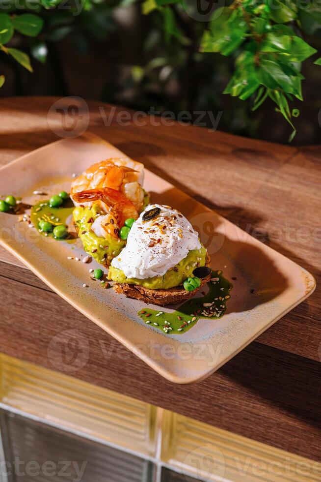 Two slices of avocado toast being served on a plate photo