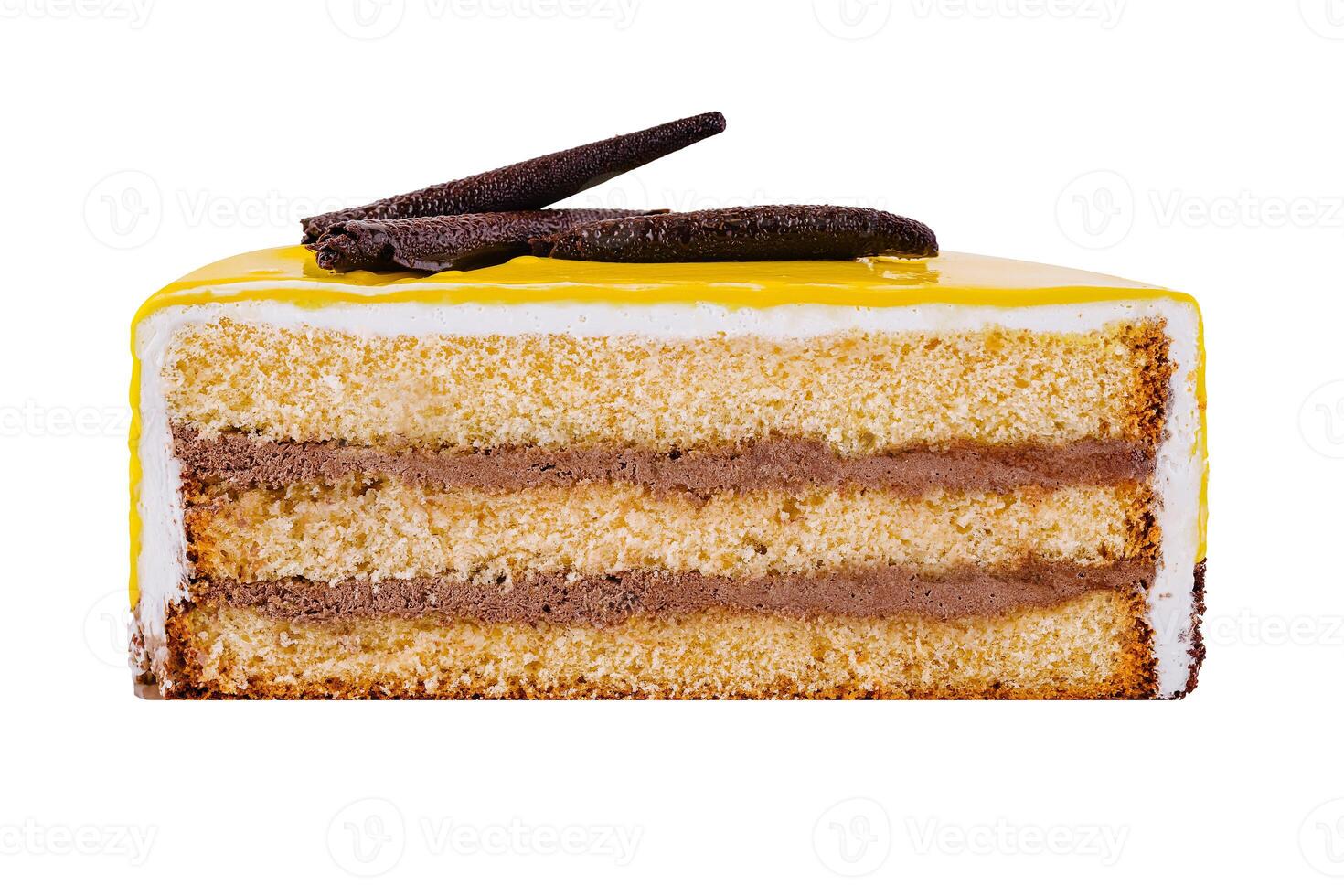 Delicious piece of cake with yellow icing and chocolate decoration isolated on white background photo