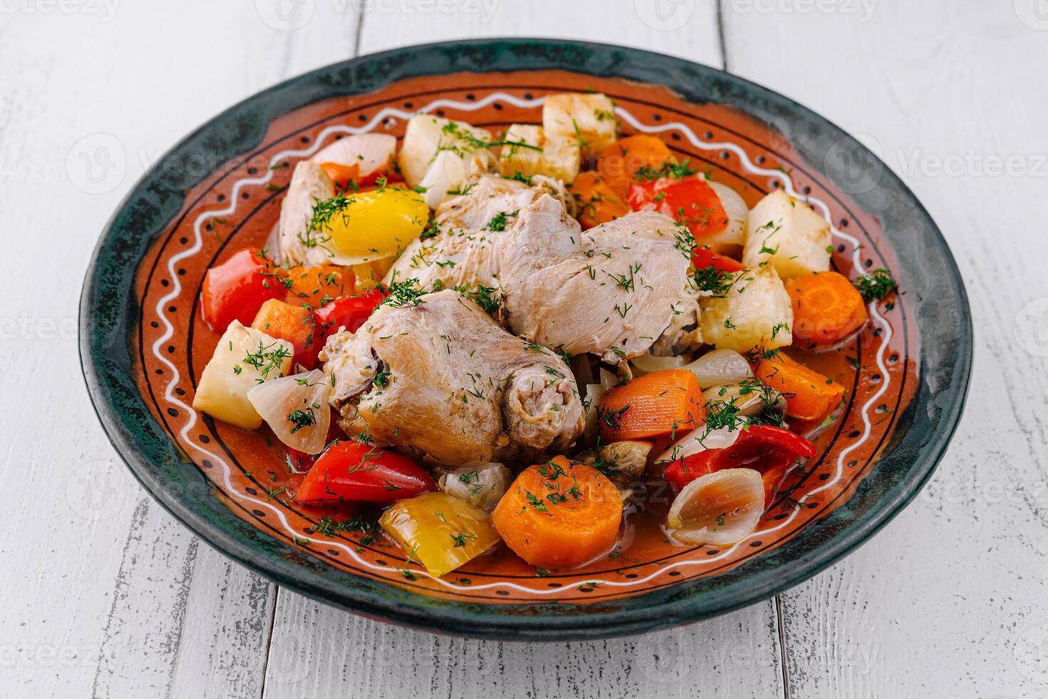 Delicious chicken stew with potatoes and carrots served on a plate photo