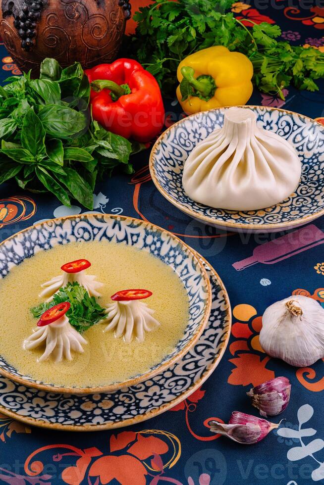 Traditional georgian food khinkali posing on a table with fresh ingredients photo