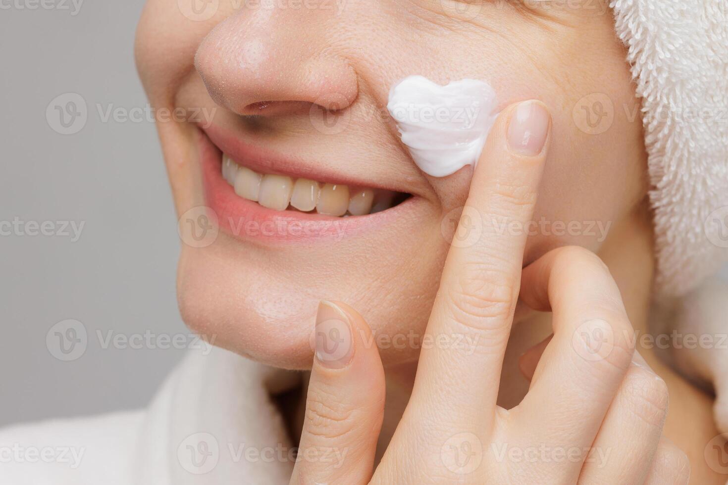 Woman Applying Heart-Shaped Cream on Her Face photo