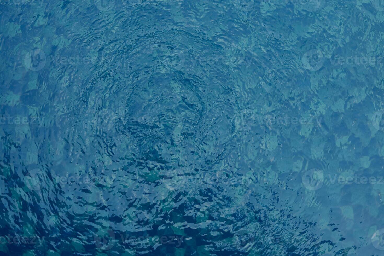 Water bubbles from the pool. Dark, sad, moody and dramatic background. Water ripple texture. photo