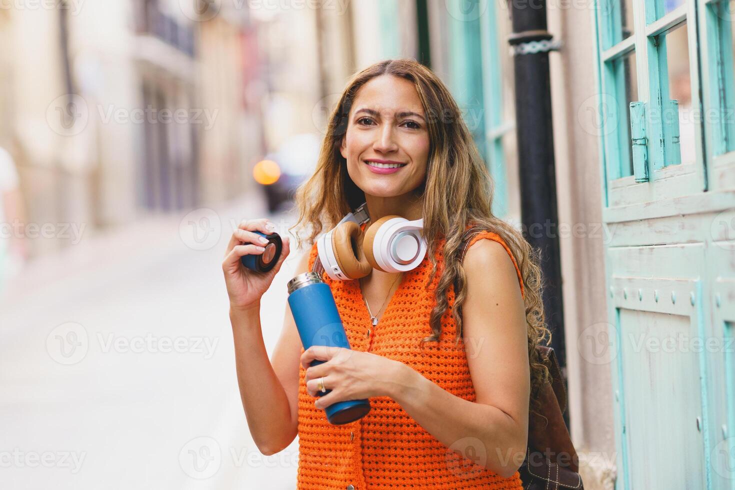Woman drinking water using reusable bottle photo