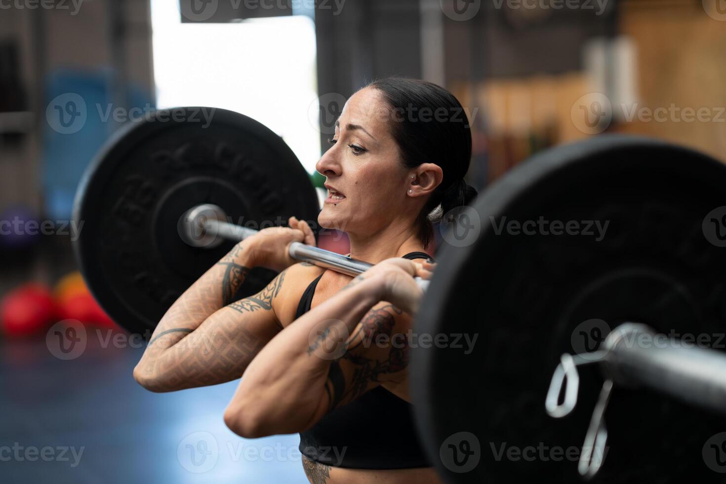 Bodybuilder working out in a cross training center photo