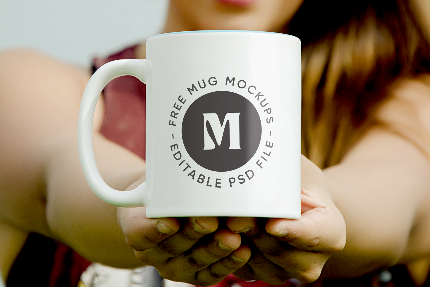 Mockup of white mug in young girl's hand psd
