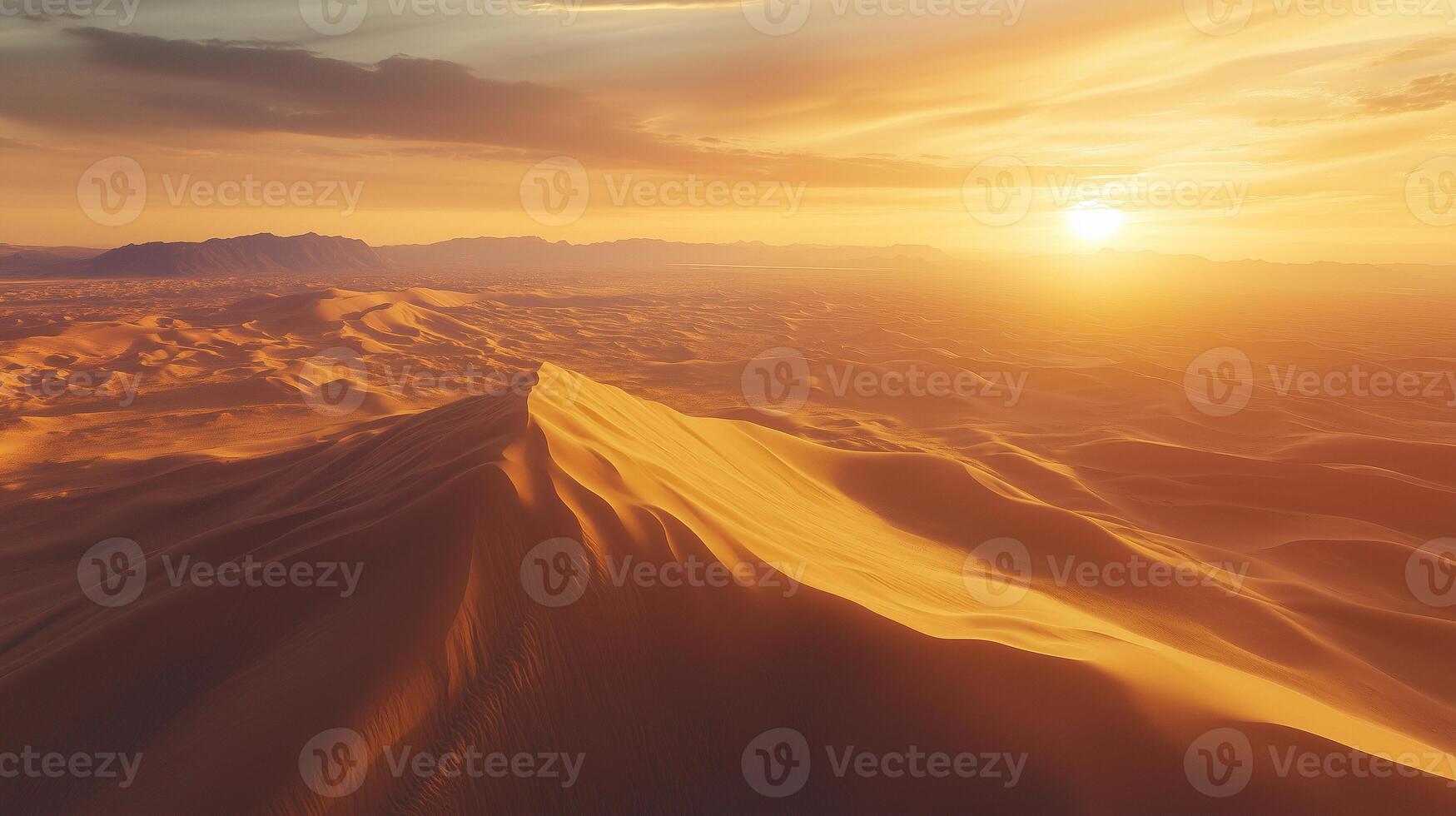 Sprawling desert landscape, captured from above by a drone. Patterns in the sand dunes with sharp shadows during the golden hour, giving a dramatic and expansive view. photo