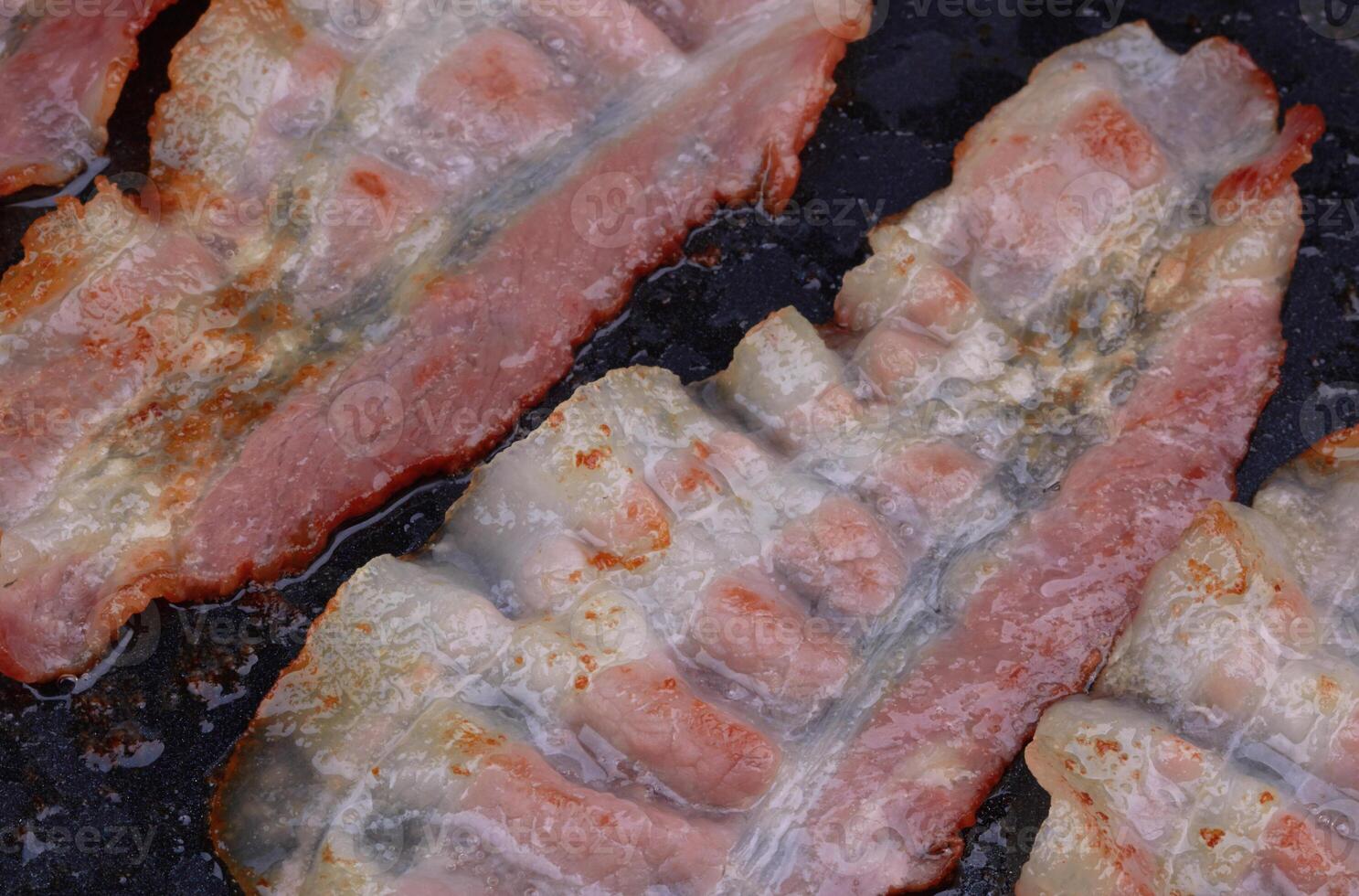 Bacon cooked in frying pan photo
