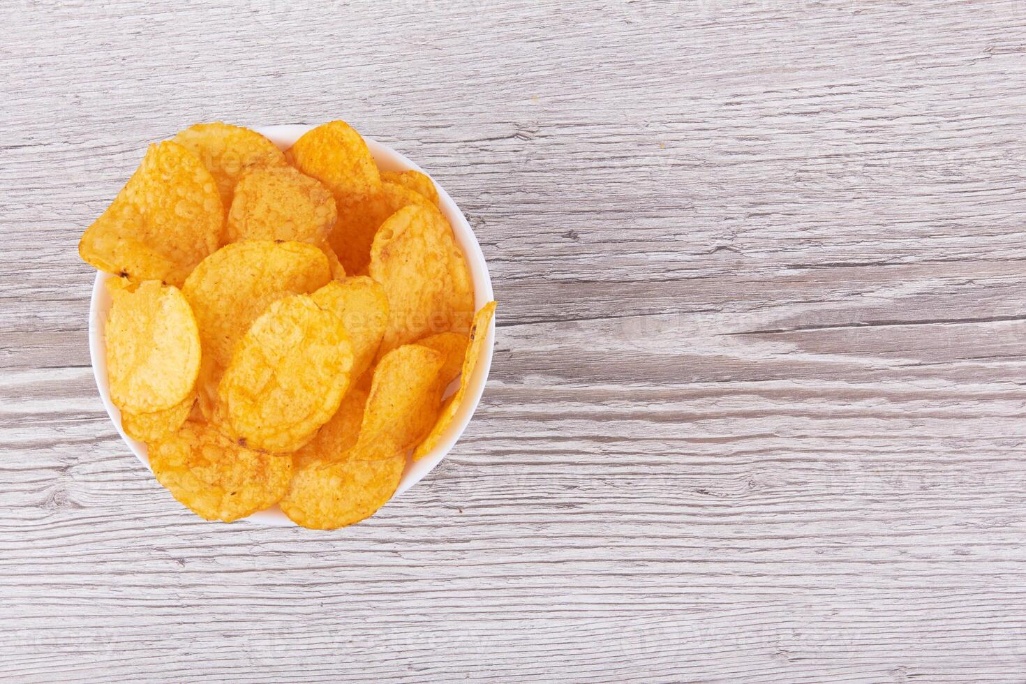 Potato chips in bowl photo