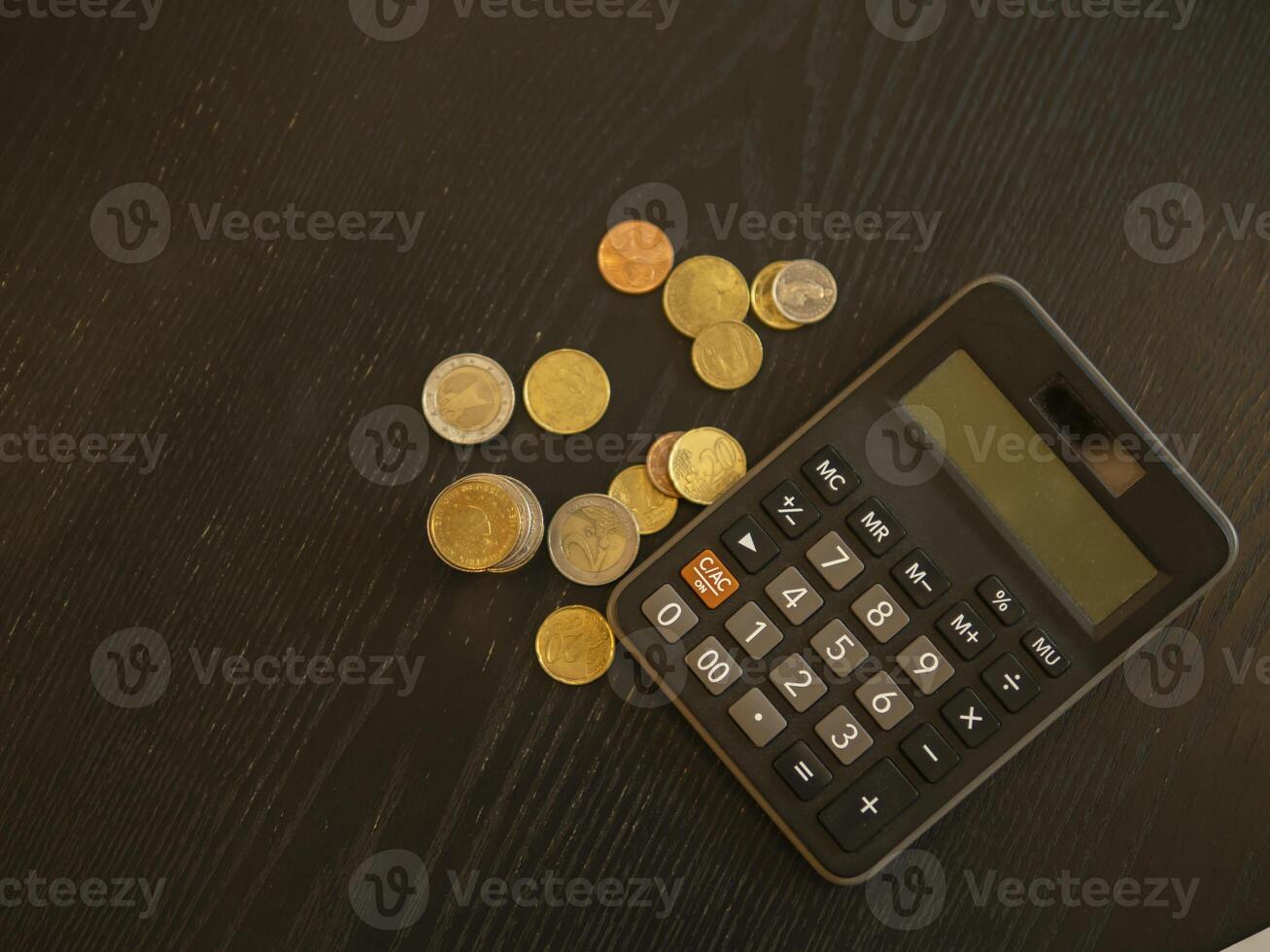Coin and calculator on wooden table, saving money for the future and life. photo
